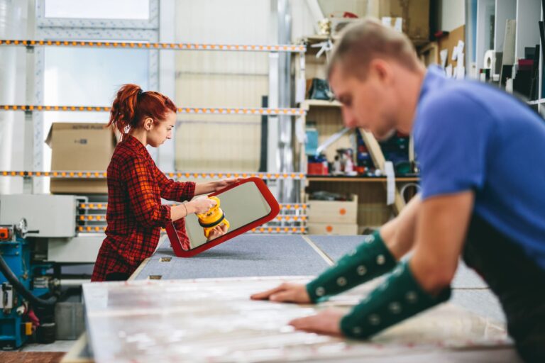mdc-man-and-woman-working-on-glass-pane-in-glazier-wor-2023-11-27-04-55-05-utc